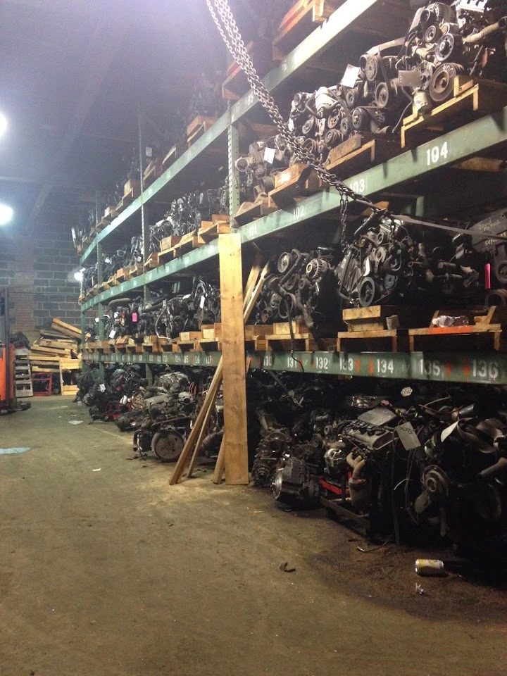 Auto parts storage with numerous engines on shelves.