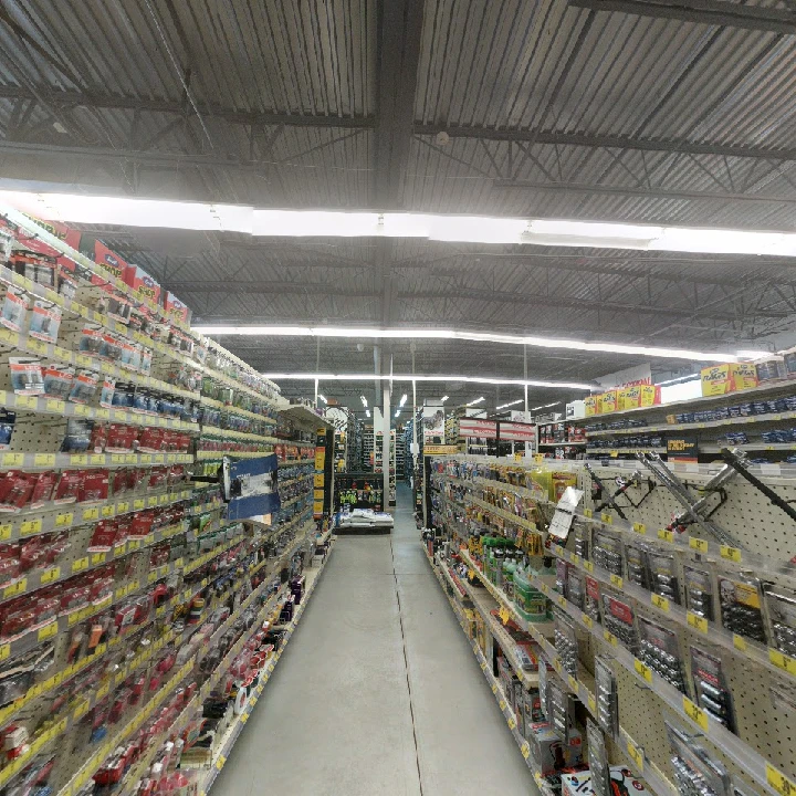 Auto parts store aisle with extensive product selection.