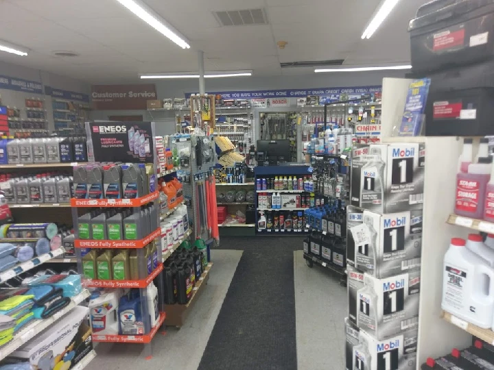 Auto parts store interior with various products displayed.