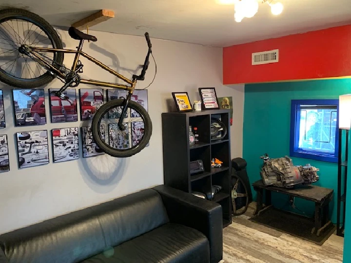 Bicycle on wall in a cozy automotive workspace.