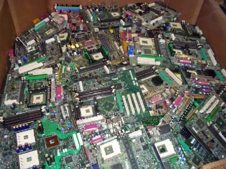 Box filled with various circuit boards for recycling.