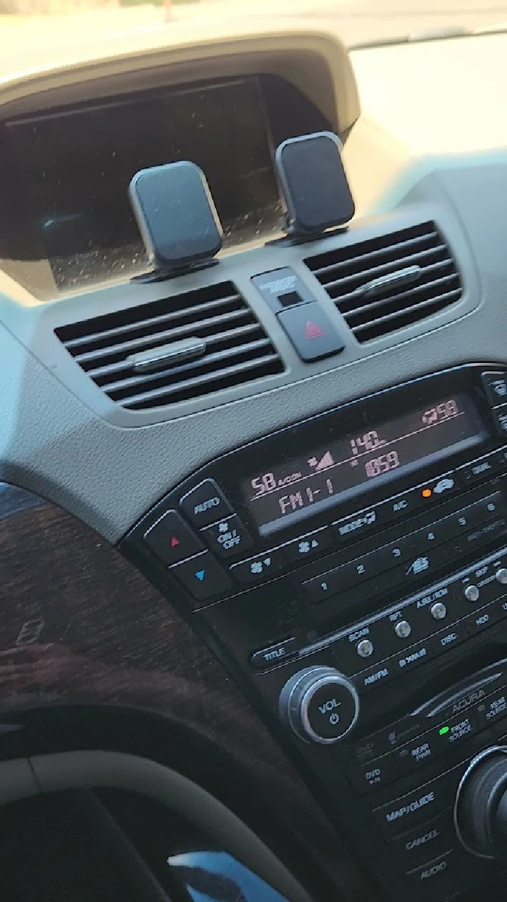 Car dashboard with radio and air vents visible.