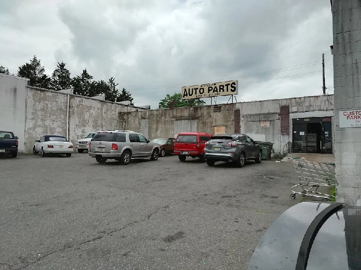 Parking lot of Royal Auto Parts with cloudy sky.