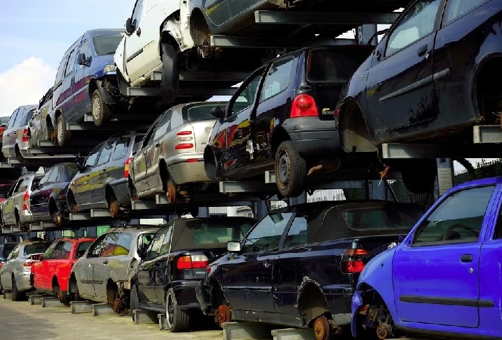 Stacked used cars at Triangle Used Auto Parts.