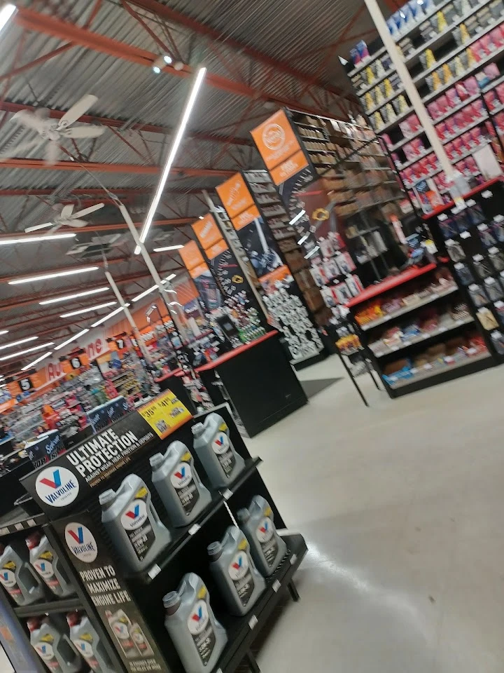 Auto parts store interior with product displays.