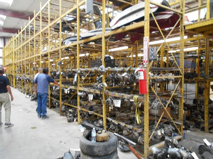 Auto parts stored on shelves in a dismantling facility.