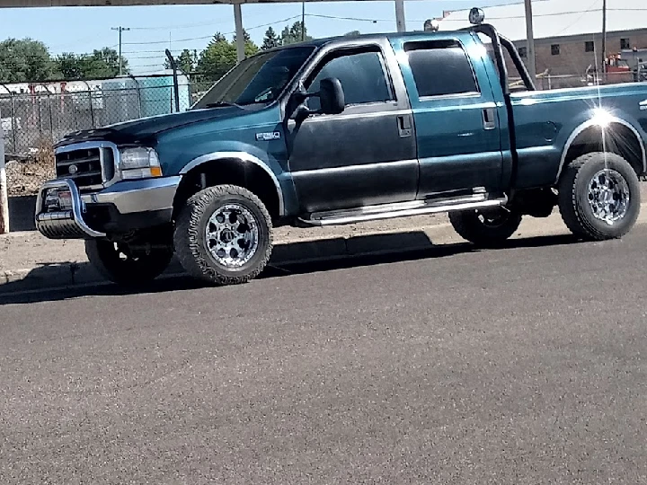 Blue Ford truck parked on the street.