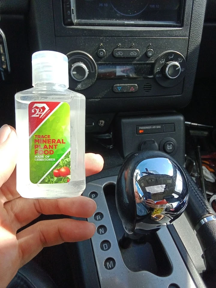 Bottle of mineral plant food in a car interior.