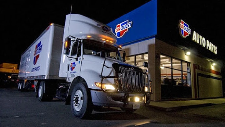 Carquest Auto Parts truck outside the store at night.