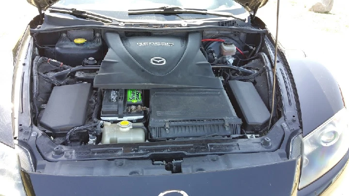 Engine compartment of a Mazda vehicle.