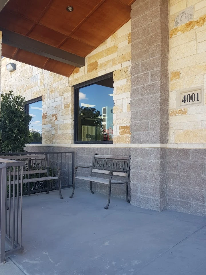 Entrance of Yourford Auto Parts building with seating.