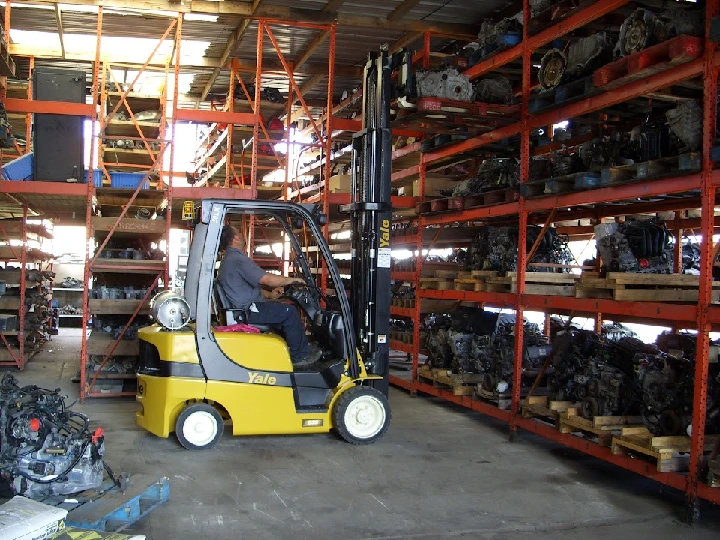 Forklift operating in an auto parts warehouse.