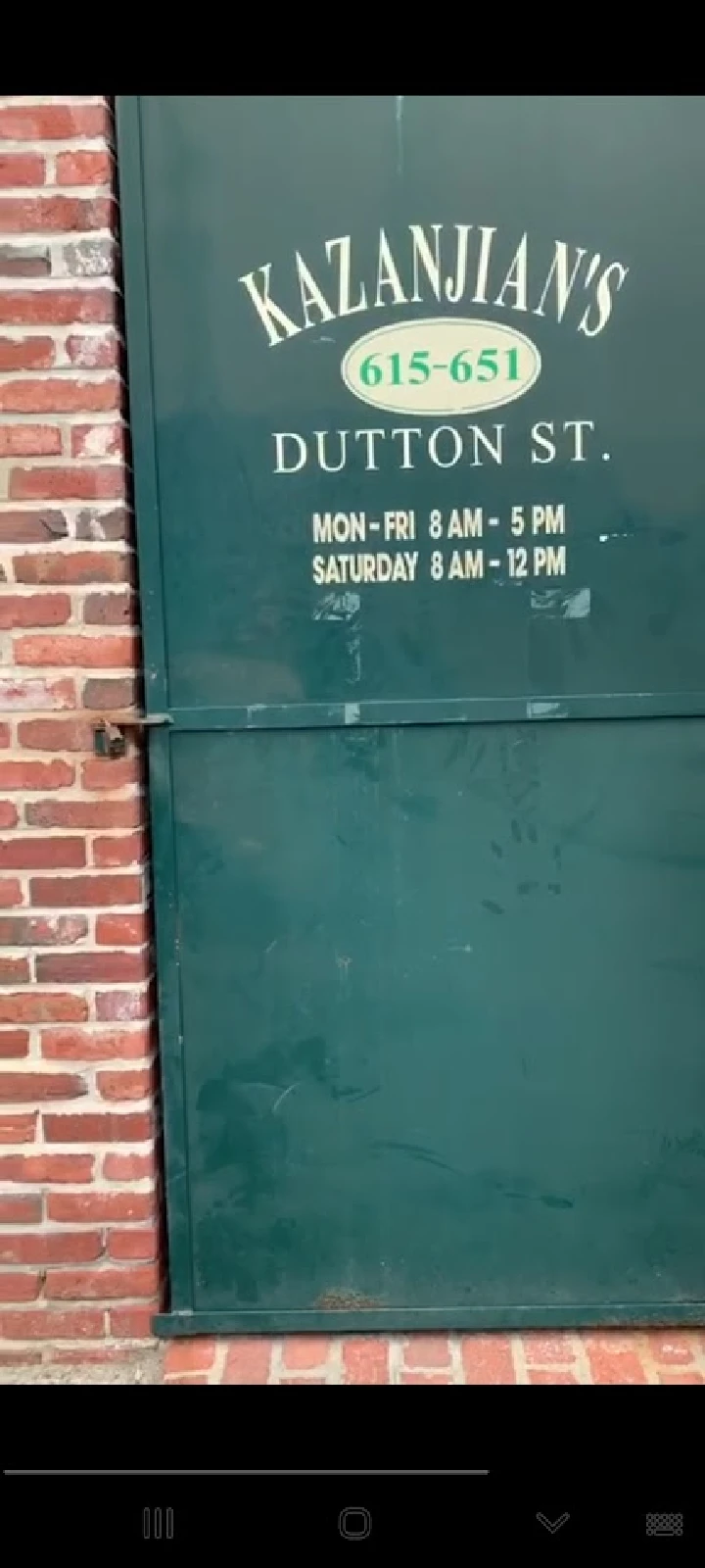 Green door with Kazanjian's sign and hours displayed.