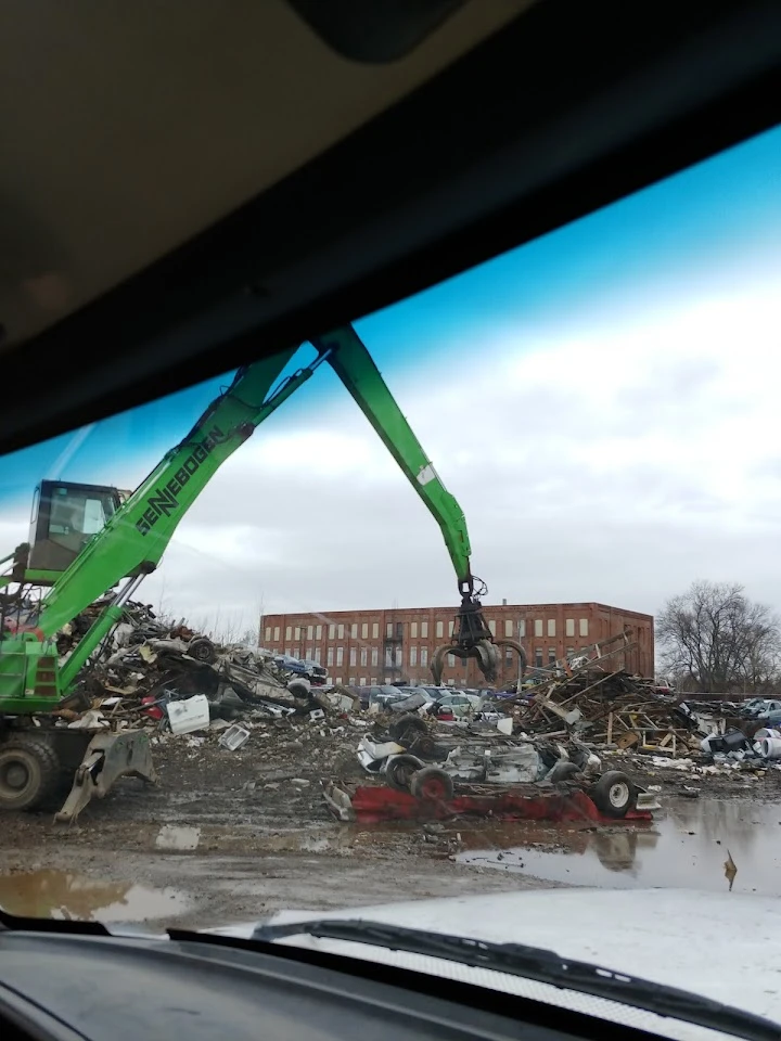 Heavy machinery sorting scrap at a recycling center.