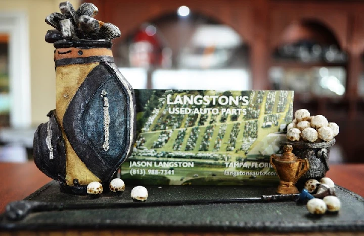 Langston's Used Auto Parts business card display.