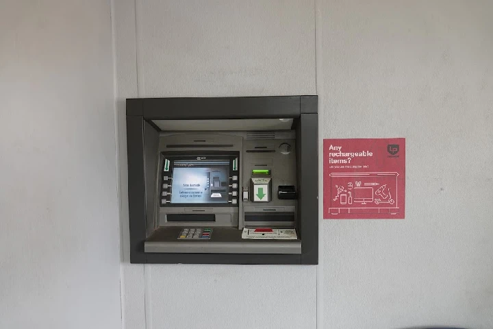 Recycling center kiosk with informational sign.