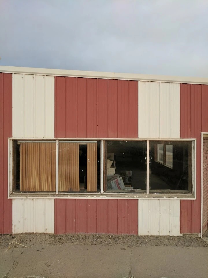 Red and white building with glass windows.