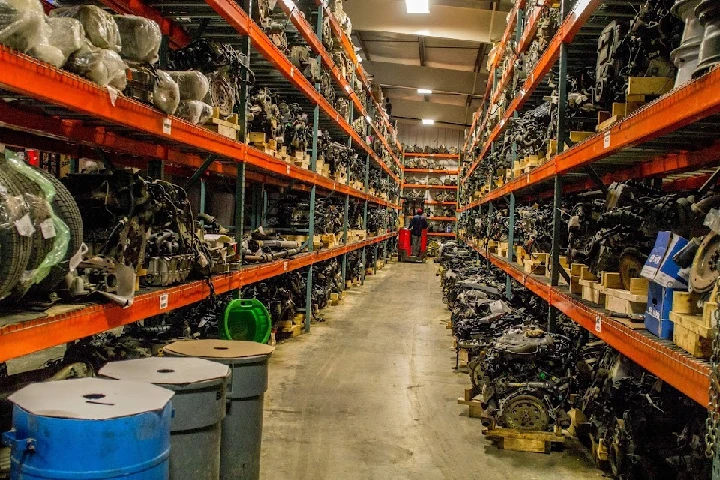 Used truck parts in a large warehouse setting.