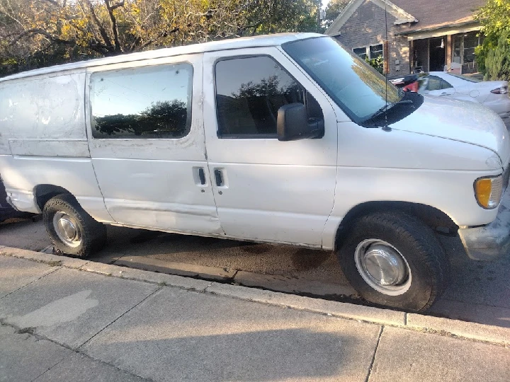 White van parked on a residential street.