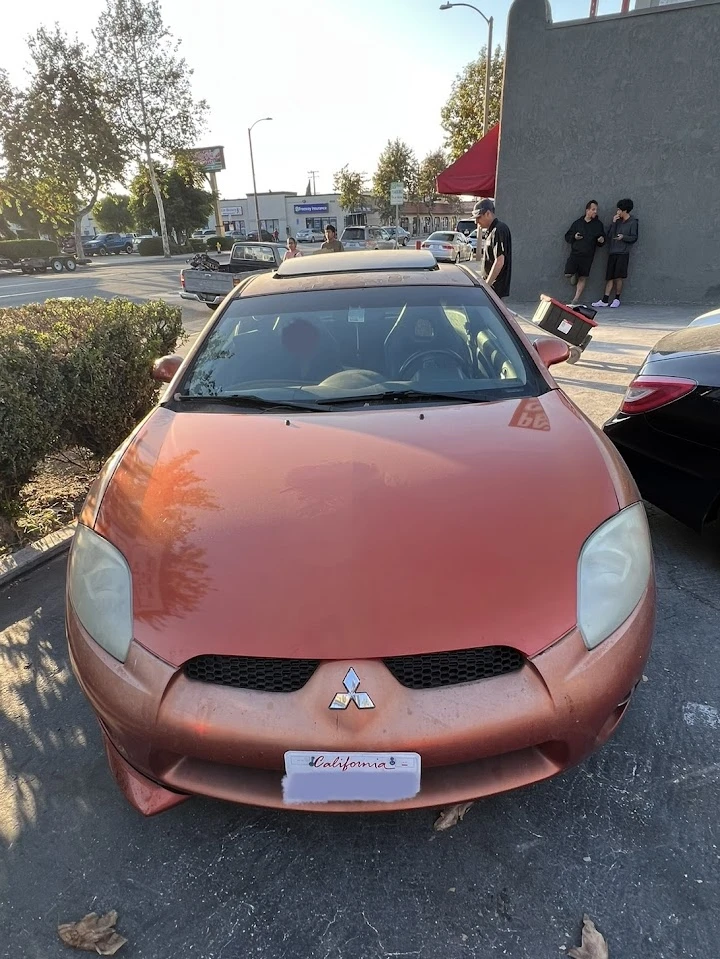 Abandoned orange car at LA Auto Wrecking.