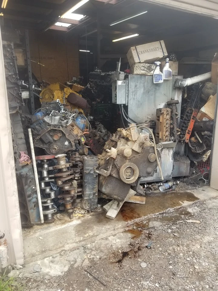 Auto parts and engines stored in a garage.