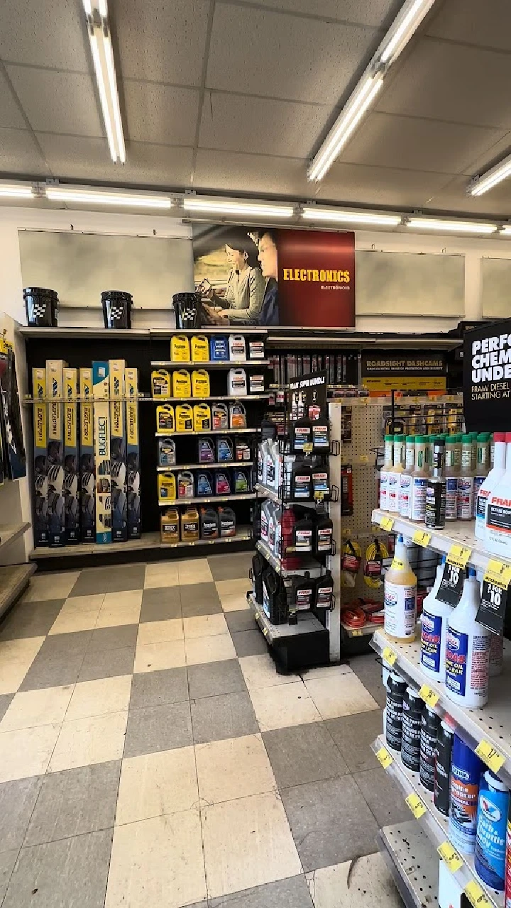 Auto parts store interior with various products displayed.