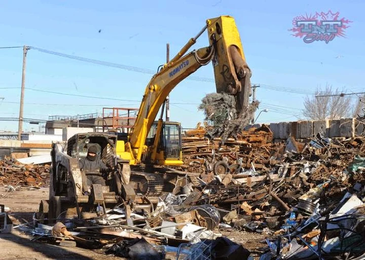 Excavator at TNT Scrap Metal yard sorting materials.