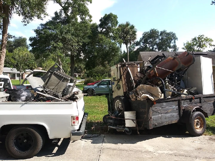 Loaded trucks with recycling materials outdoors.