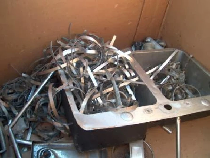 Metal scrap pile in a recycling container.