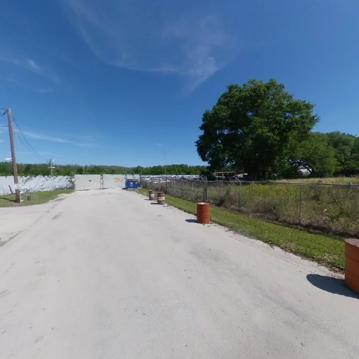 Osceola Auto Salvage lot with clear blue sky.