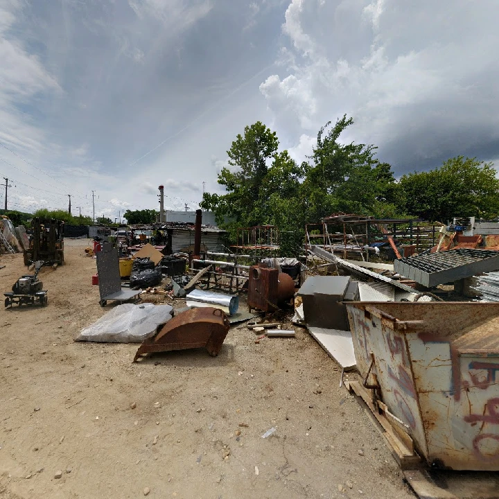 Recycling yard filled with various metal scraps.