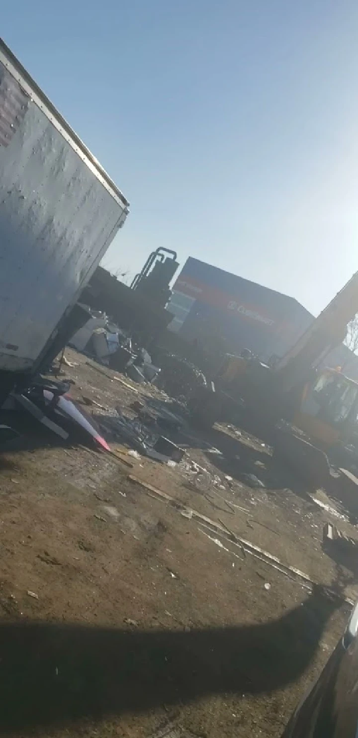 Scrapyard with metal debris and machinery.