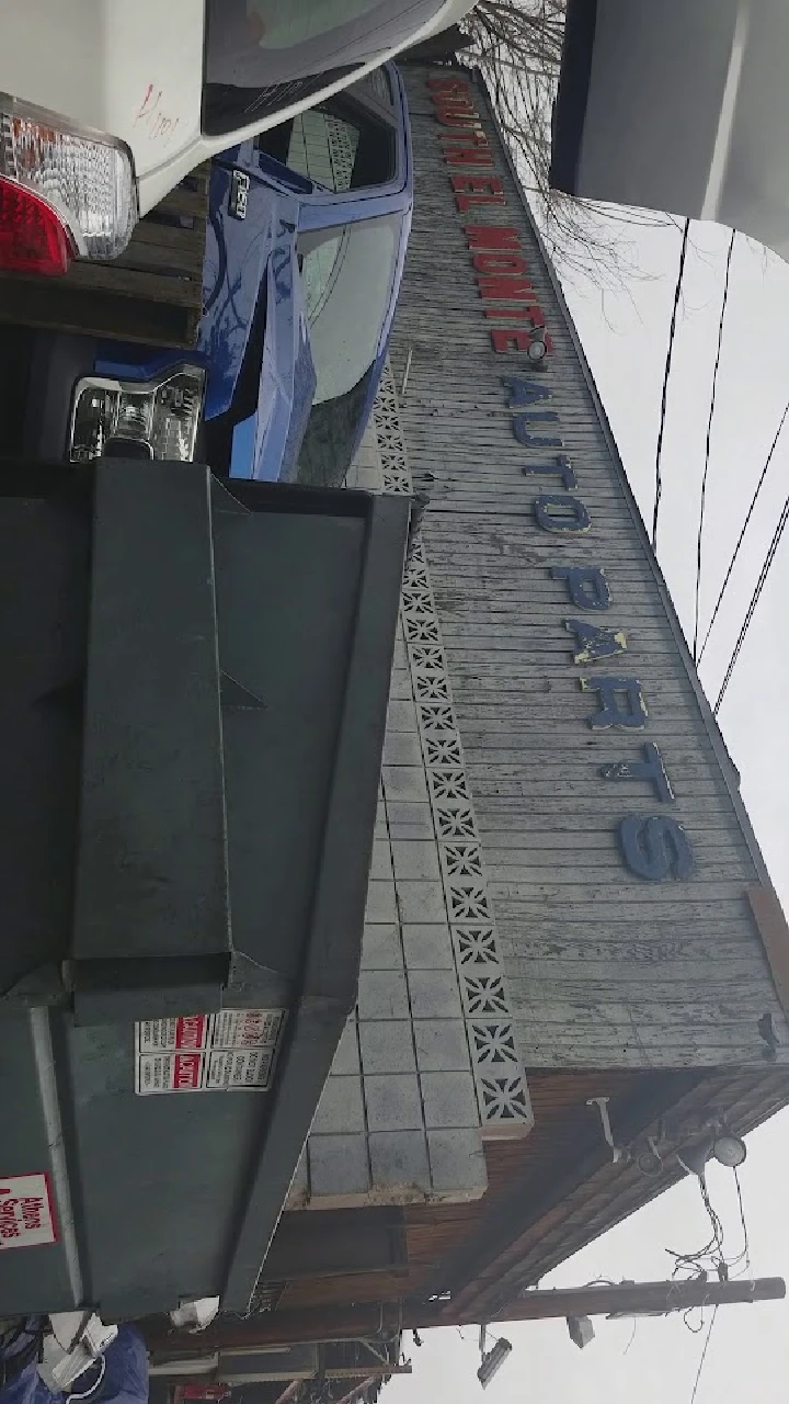 South El Monte Auto Salvage sign with vehicles nearby.