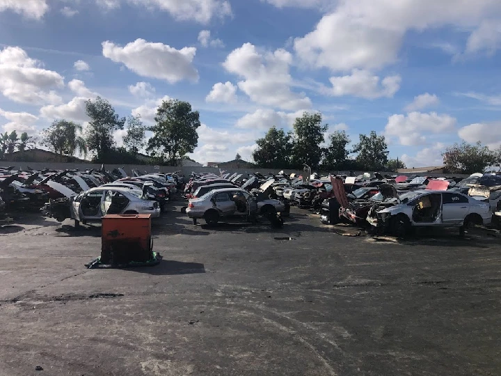 A junkyard filled with dismantled vehicles.