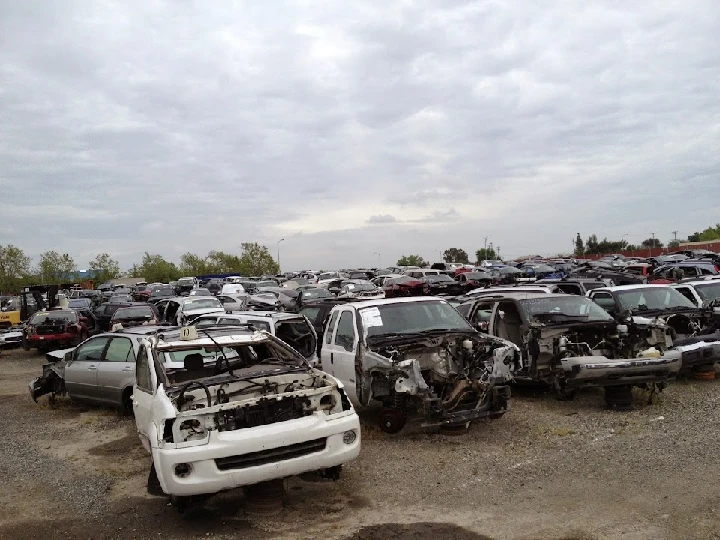 Aerial view of a junkyard filled with cars.