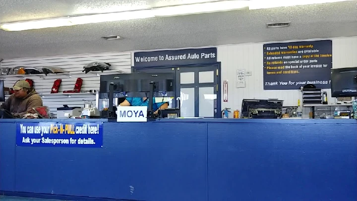 Auto parts counter with staff and signage.