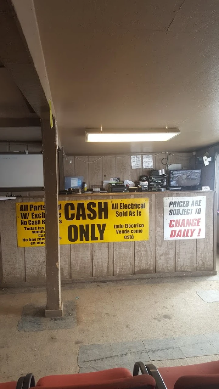 Auto parts shop interior with cash-only signs.