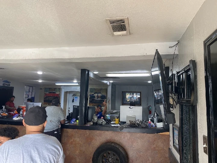 Auto parts store interior with staff assisting customers.