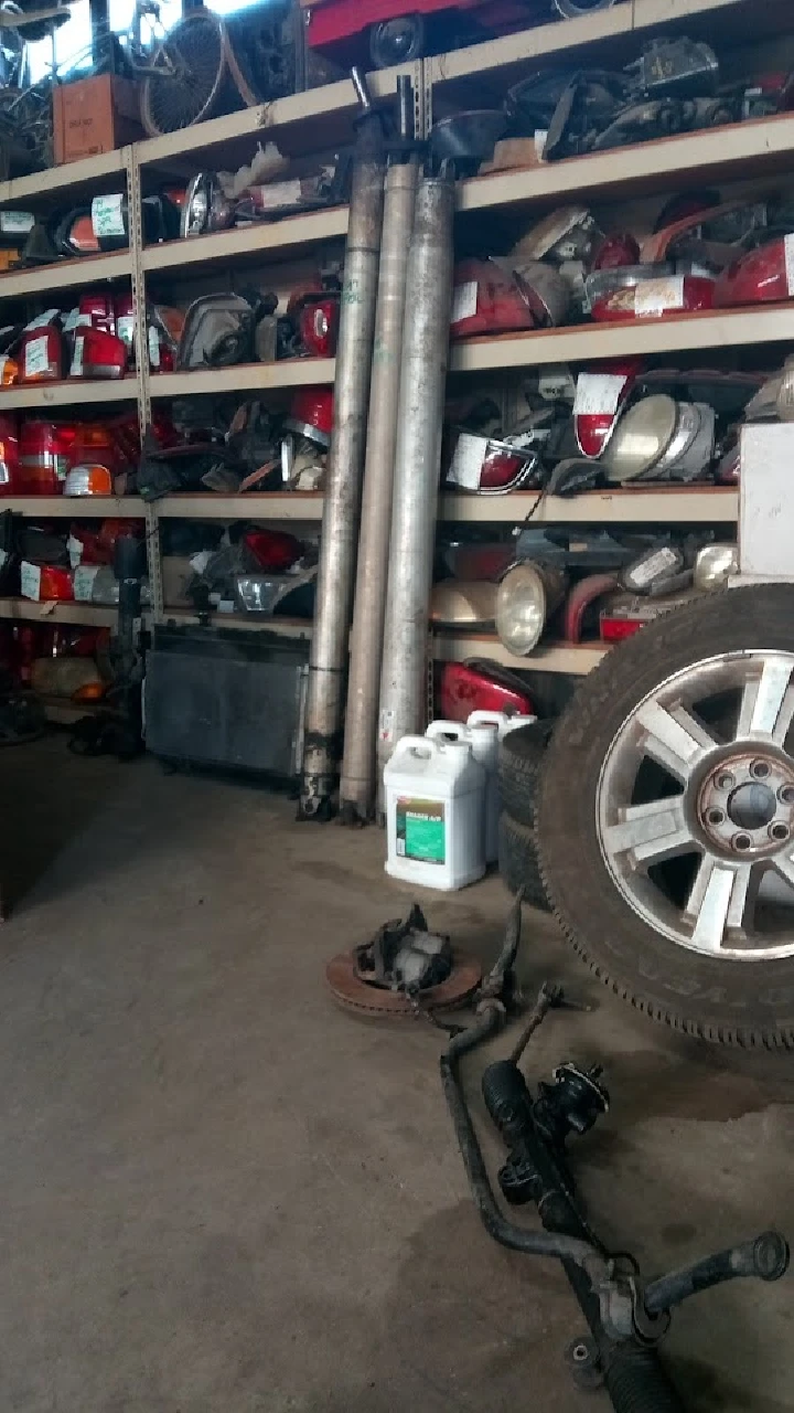 Auto parts and tools in a junkyard setting.