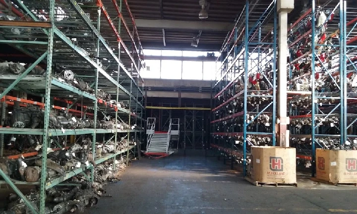 Auto parts warehouse with organized shelving units.