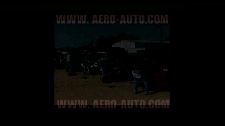 Auto salvage yard with customers pulling parts.