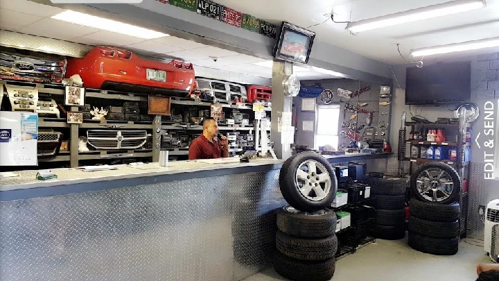 Automotive shop interior with tires and parts.