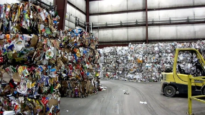 Bales of recycled materials in a warehouse.