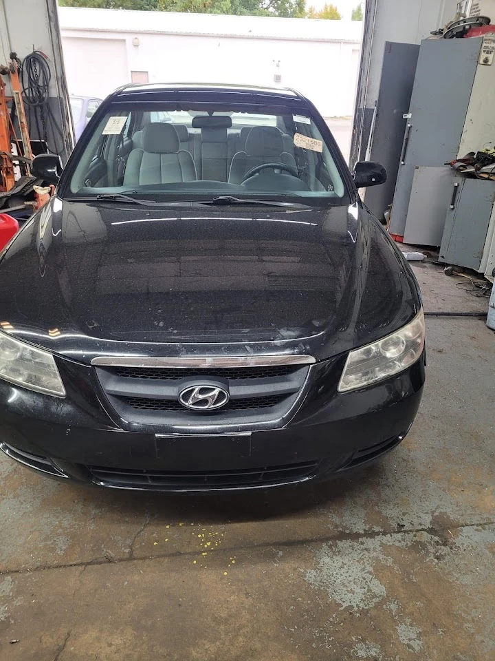 Black Hyundai sedan in a garage setting.