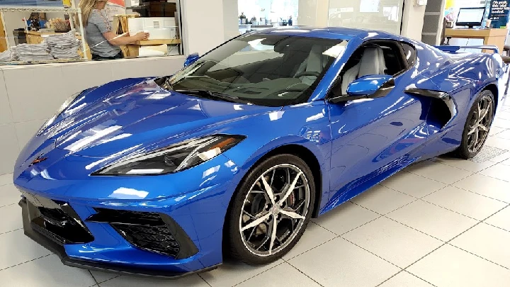 Blue sports car displayed in a showroom.