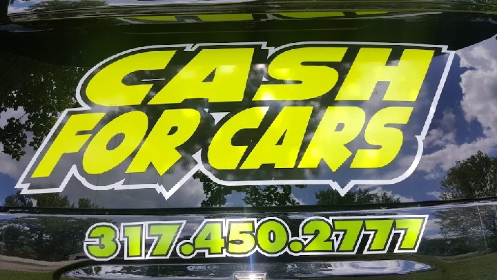 Bright sign for TJ's Cash 4 Cars with contact info.