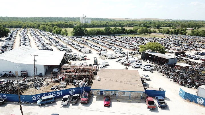 Brothers Auto Parts yard with numerous vehicles.