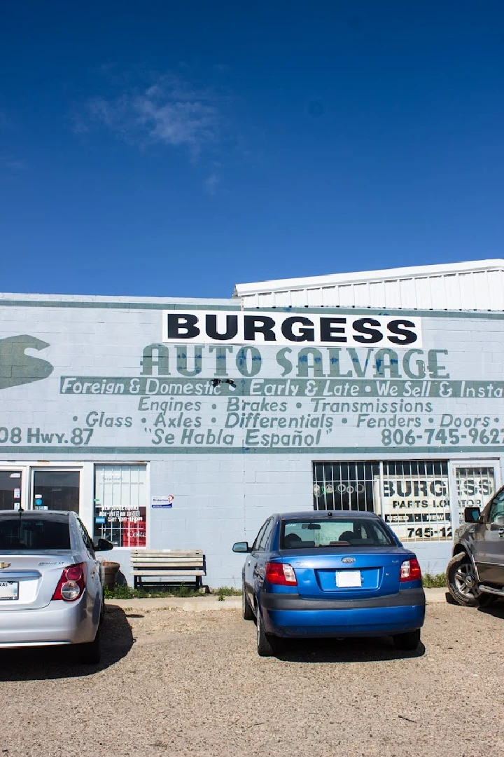 Burgess Auto Salvage building with parked vehicles.