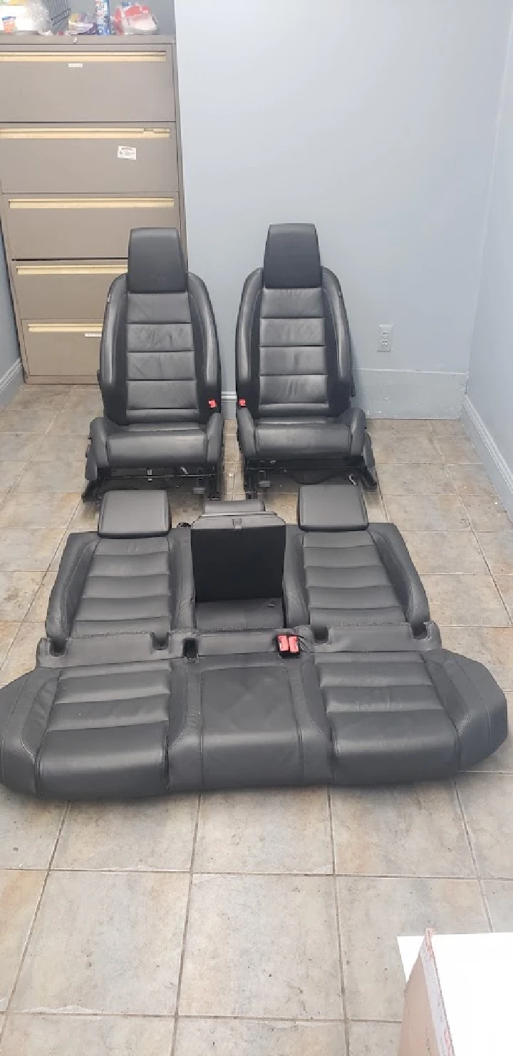 Car seats arranged on the floor for inspection.