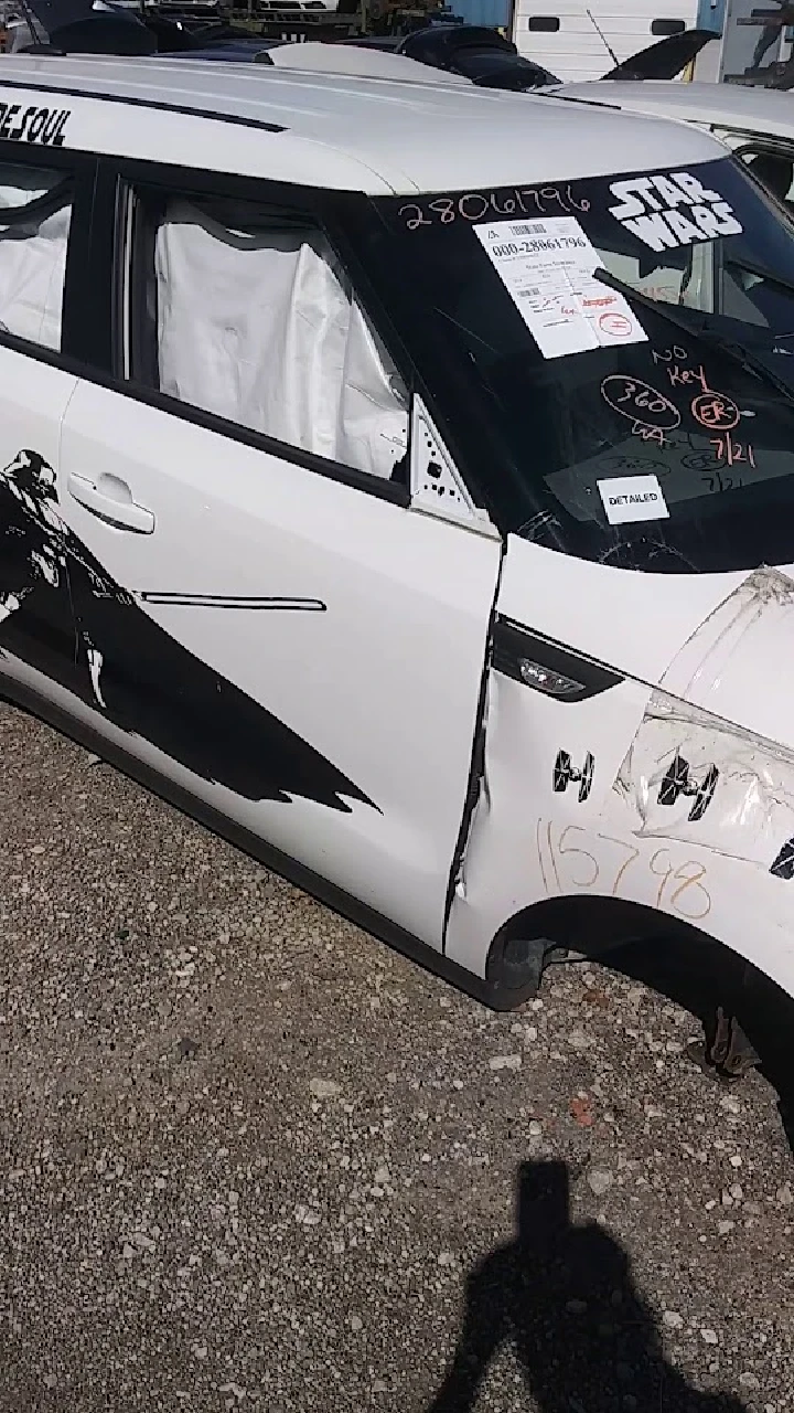 Damaged white vehicle with Star Wars decals.